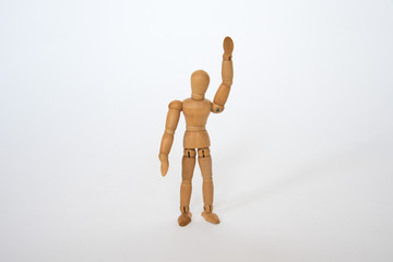 Wooden figure pose raised hand on white background isolated object
