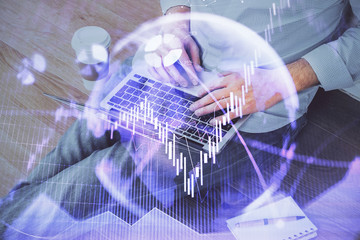 Forex graph with businessman working on computer in office on background. Concept of analysis....