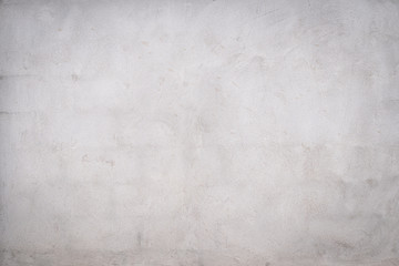 Gray concrete wall texture painted with white. The old white color that has been fading and peeling off. Texture of old dirty concrete wall for background.