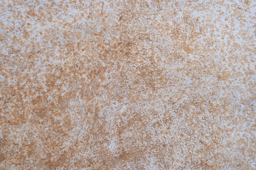 The brick wall is roughly plastered with cement. Revealing the brown brick texture inside. More texture of old dirty concrete wall for background.