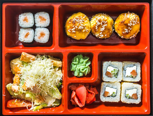 Professional chef cooking in the kitchen restaurant at the hotel, preparing dinner. A cook in an apron makes a salad of vegetables and pizza.
