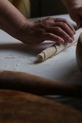  hands of a woman cooking homemade egg noodles