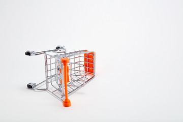 Overturned shopping cart on white background