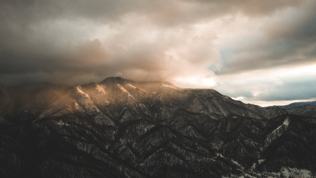 Sun over the cloudy mountain. Drone view © razvanli
