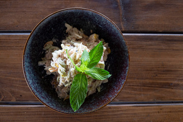 Salad with tuna fish and mayonnaise, mint for decor