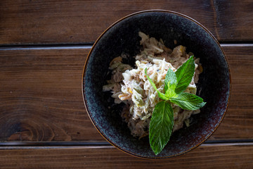 Salad with tuna fish and mayonnaise, mint for decor