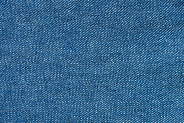 Clean blue jean denim top view close up shot to the detail of fabric. textile material and cotton patter tough and durable garment fashion style. For background or wallpaper with copy space for text.