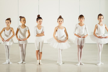 ballet, dance concept. Choreographic dance of group of caucasian graceful beautiful little ballerinas practicing together during classes in classical ballet school