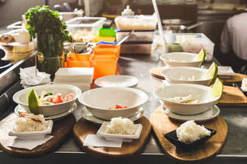 Professional chef cooking in the kitchen restaurant at the hotel, preparing dinner. A cook in an apron makes a salad of vegetables and pizza.
