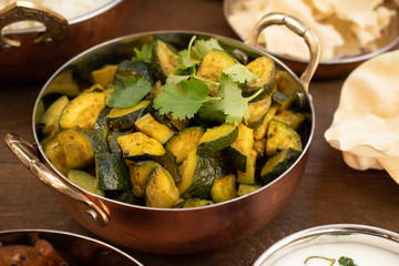 Indian style zucchini curry served in copper bowl