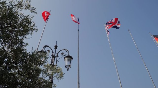 Flags on Blue Sky. Garda Lake, Italy. Lasize pier area