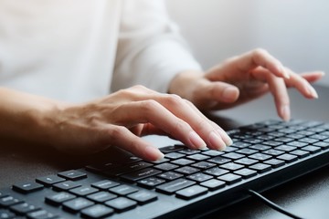 2 hands of Asian woman is press, typing on 2 language keyboard as Thai and English. Maybe...