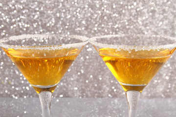 Two glasses with a yellow cocktail