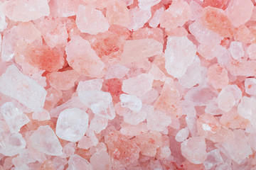 Grains of crystals of pink Himalayan salt, closeup shot on macro.
