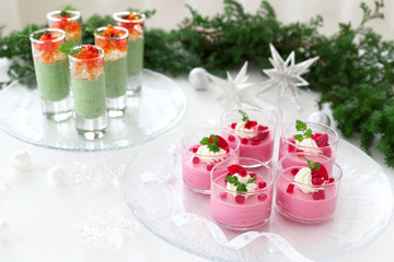 Christmas appetizers, mousse with beetroot , avocado and spinach in glasses.