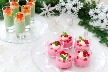 Obraz na płótnie Canvas Christmas appetizers, mousse with beetroot , avocado and spinach in glasses.