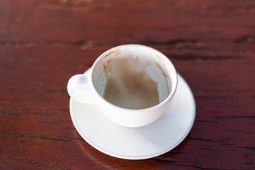 Empty coffee cup after drink on wood table In the coffee shop