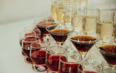 Glasses with alcohol drinks are on the catering table Selective focus, space for text.