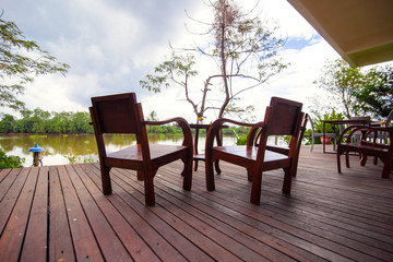 Obraz premium Empty tables and chairs on terrace riverside at hotel, resort.
