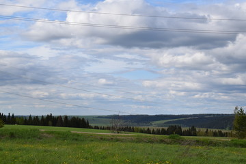landscape with green field and blue sky