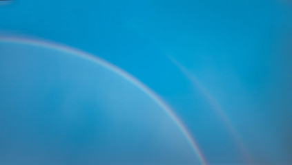 Double rainbow blue summer sky