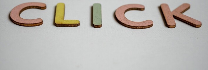click here made from wooden letters 