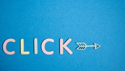 click here made from wooden letters 