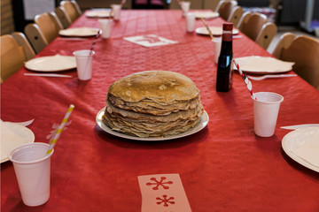 stack of pancakes on a red tablecloth