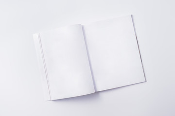 Flat lay mockup with white open magazine on a white background