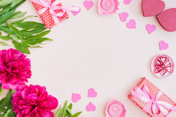Flat lay valentines day frame with red peonies and gift box on a color background
