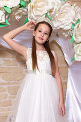 Portrait of bride with diamond diadem in hair on the background of flower arch