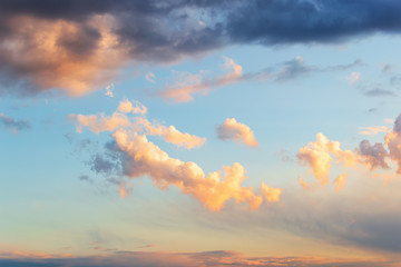 Beautiful golden cloud in a blue sky just before sunset. Scenic sundown cloudscape for background....