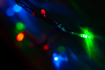 Multi-colored lights of Christmas garlands. Colorful holiday lights