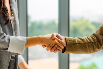 business man and business woman handshake after completed agreement. Business concept in office.