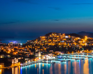 Fototapeta na wymiar Night view on the town on a hill. Beautiful sea view with lights