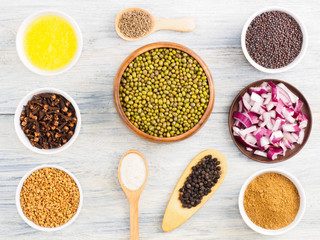 Ingredients for cooking mung bean: butter, onion, cumin (jeera), black pepper, masala, fenugreek, mustard seeds, salt, cloves. Healthy eating concept