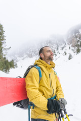 Fototapeta premium Free rider going up the mountain with his snowboard