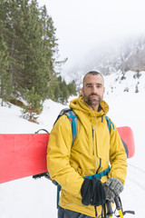Fototapeta premium Free rider going up the mountain with his snowboard