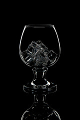 glass of scotch whiskey with ice on black background