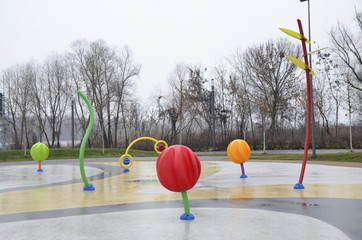 Sports and recreation. Happy childhood. In a beautiful park, a large playground has been built with slides, labyrinths, cars, steam locomotives.