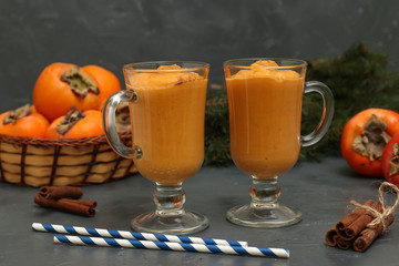 Homemade smoothie of persimmon with cinnamon on a dark background, horizontal orientation