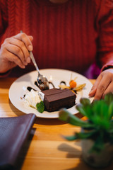 Fototapeta na wymiar Woman eating chocolate cake in a restaurant