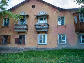 Shabby facade of an old house. Summer sunny day