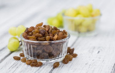 Portion of fresh Raisins on an old wooden table