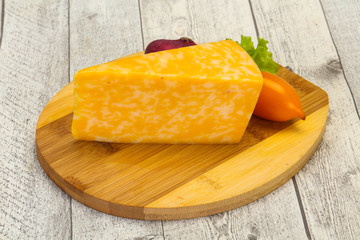 Marble cheese  triangle over wooden