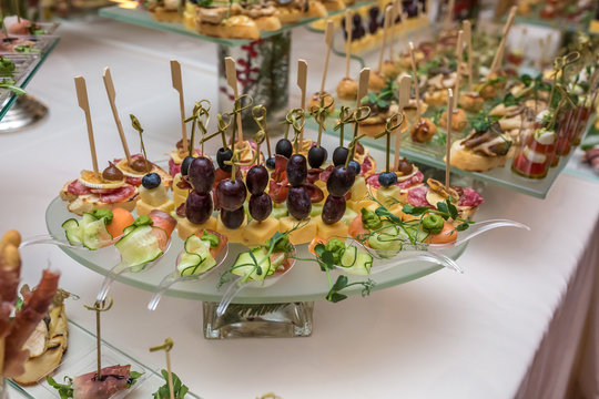 Catering. Off-site food. Buffet table with various canapes, sandwiches,  hamburgers and snacks. Stock Photo | Adobe Stock