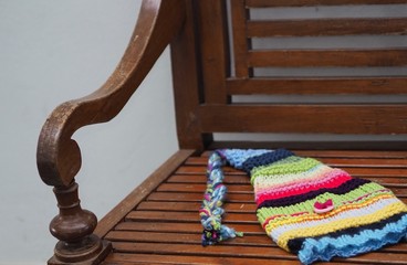 Fototapeta na wymiar knit elf hat on a wooden bench 