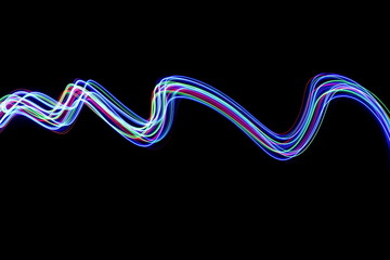 Long exposure photograph of neon colour in an abstract swirl, parallel lines pattern against a black background. Light painting photography.
