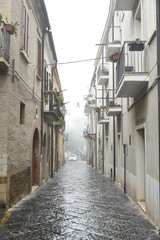 Ancient Houses and Buildings in Troia, Foggia, Italy, at Morning with Foggy Weather