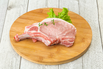 Raw pork bone steak over wooden